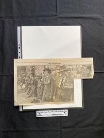 A large newspaper clipping of a large and a small black and white photo