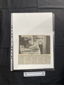 A newspaper clipping of a large black and white photo with a title and five columns of text beneath.