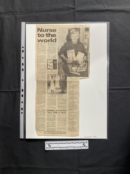 A newspaper clipping of a title, four columns of text and two black and white photos