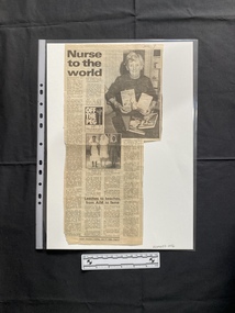 A newspaper clipping of a title, four columns of text and two black and white photos