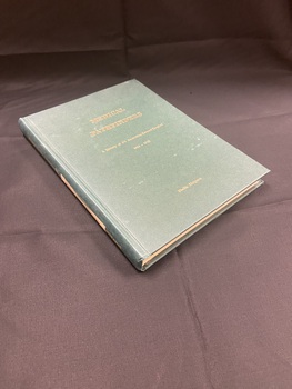 Green hardcover book with gold lettering on the front and spine showing the title and author. There is a white label taped along the  spine with 2/1 AGH written faintly.