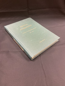 Green hardcover book with gold lettering on the front and spine showing the title and author. There is a white label taped along the  spine with 2/1 AGH written faintly.