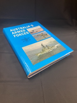 Dark blue hardcover book with bright blue dust jacket. Title at the top of the cover and along spine. There are three photographs on the front cover in separate boxes, one of a tank, one of a fighter plane, and a larger one at the bottom of a ship in the water.