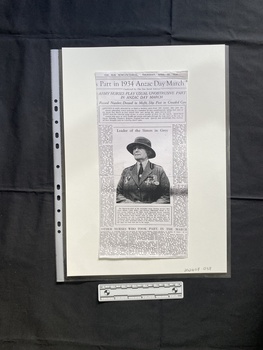 A photocopy of a newspaper clipping consisting of titles, one large photo and several columns of text