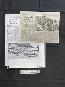 A newspaper clipping and a photocopy of it, consisting of title, five columns of text and a black and white photo (two  photos on the photocopy)