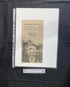 A newspaper clipping consisting of titles, four columns of text and a black and white photo