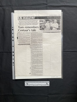 A large photocopy of a magazine article with a small black and white photo in the top right corner, of a woman and an older man holding an object, and two columns of text