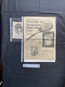 Two newspaper clippings: The large clipping is a full page story with a large title, seven columns of text and three pictures. The small clipping is of a photo and a caption