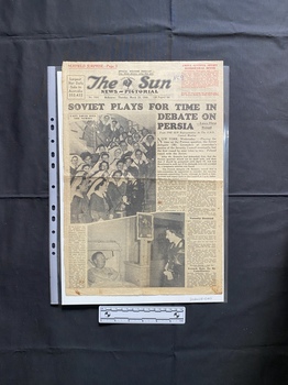 A large newspaper page with two large black and white photos that are relevant.