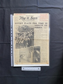 A large newspaper page with two large black and white photos that are relevant.