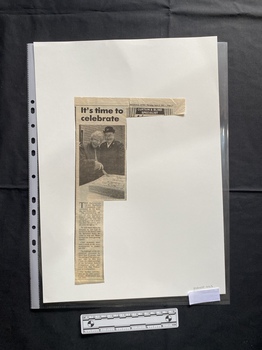 A small newspaper clipping of a title, black and white photo and a column of text
