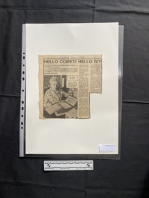 A small newspaper clipping of a title, two columns of text and a black and white photo.  The story continues on the reverse side.