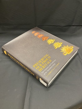 Black dustjacket on hardcover book. Front cover has images of seven different Australian military badges down the right hand side. Bottom left corner has the title printed in gold, followed by the sub-title in white, author's names in gold print. This information is repeated on the spine in the same colours.