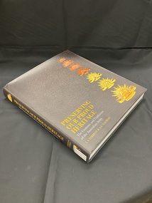 Black dustjacket on hardcover book. Front cover has images of seven different Australian military badges down the right hand side. Bottom left corner has the title printed in gold, followed by the sub-title in white, author's names in gold print. This information is repeated on the spine in the same colours.