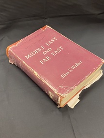 Burgundy cloth-bound book with torn burgundy dust-jacket. Series title printed in black across the top of the cover and title printed in white across the centre. Author's name printed in white across the bottom of the cover. The spine contains the same information, it is quite worn and marked.