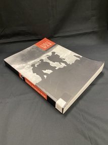 Paperback cover with black spine. The spine contains a red panel with title details and a silhouette of a soldier. The front cover is a black and white image of the silhouettes of three soldiers, there is a red panel in the top right corner showing the title and author.