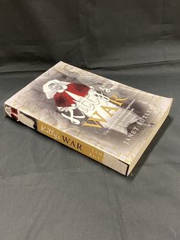 Olive green paperback cover. The spine shows the title in black and white print with an image of a nurse at the top. The front cover has a full page image of a woman in a white nurse's uniform with red cape and the title overlaid over the top.
