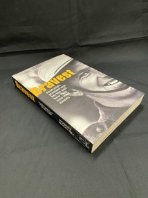 Black paperback book with a close-up, black and white image of part of a soldiers face. The title is printed in yellow and the sub-title and author in white. 