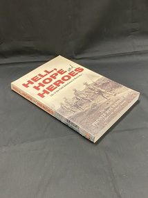 Paperback book with title printed in red print across the front and spine on a cream coloured background. The lower half of the cover contains an image of soldiers walking in a line along a path on barren land, the first soldier carries a white flag, behind him two of the other soldiers carry a wounded soldier on a stretcher. followed by two more soldiers.