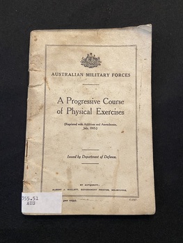 Small staple-bound booklet with a cream cover displaying a black double-line border on the front cover containing text printed in black. There is a white spine label attached to the base of the spine.