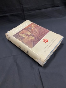 Blue cloth-bound hardcover book with a worn cream coloured dust-jacket. The title is printed in white across the top, beneath which is an illustration of three jeeps driving in a row (from the perspective of someone sitting in the back seat of the third jeep). The bottom of the page displays black text with a red star above it with the letters ACF inside.
