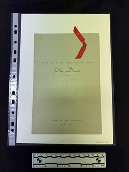 Grey card two fold menu with a Scarlet red ribbon on top right corner on cover. Black text visible on the front.