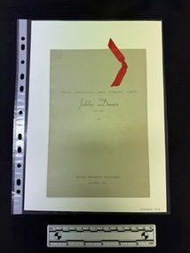 Grey card two fold menu with a Scarlet red ribbon on top right corner on cover. Black text visible on the front.