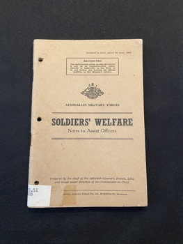 Staple-bound cardboard cover. Item has three holes punched down the left side. Restriction note typed inside a black border at the top of the page. Australian emblem is displayed beneath with the words 'Australian Military Forces'. The title is printed in black ink between two double lines. The bottom of the cover contains the publication details in smaller black font.