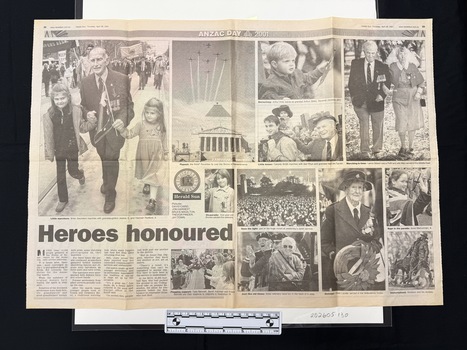 Two page black and white newspaper spread with twelve photographs of people in small and large groups and a statue.  Some people are in uniforms with medals, others are waving flags.  All photographs have captions and there is a brief four column article.