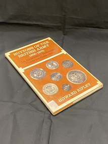 Thin hard cover book with a cream coloured dust jacket. Title and author printed down the spine and a spine label taped to the base. Front cover divided into two brown templates. The top one covers a third of the page and shows the title in cream print and subtitle in black. The bottom template is a larger square and contains examples of seven different silver buttons, with the author's name at the bottom.