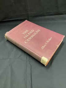 Worn, maroon hard-cover book with maroon dust-jacket Title printed in cream across the spine. Spine label taped to base of spine. Series title printed in black at the top of front cover, title and author printed beneath in cream text.