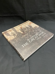 Paperback book. Black and white image of soldiers in uniform standing in front of and on top of a tank, wraps around the full cover. Title is overlaid in white print on the front and on the spine.