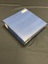 Three ring binder photograph album. The cover is mottled dark blue and black. There are five sets of three gold horizontal lines spaced out down the spine. At the top of the spine is a large white sticker with PA54 in red marker. The top right corner of the front cover has a label with the title handwritten on it in black ink.
