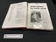 An example of the inside page layout displaying two open pages and the spiral binding in the centre. One side has a printed and typed annual report and the right side has a copy of a newspaper clipping.