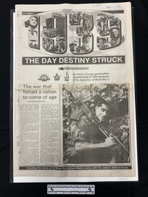 A large black and white newspaper lift-out with the cover showing the numerals 1939 filled with photos collaged together, several large headlines and subtitles, one article with two columns and a large captioned photo of a man in uniform with a gun on his shoulder, cigarette in his mouth, wearing a hat.