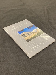 Grey paperback booklet with title printed in white text down the spine and across the front cover. There is a column of white lines running down the left side of the cover and a colour photo of the Australian War Memorial in the centre right of the cover.