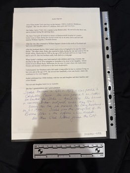 Single sheet of paper with text on one side, the upper 2/3 of the page is printed text and below is handwriting in blue ink.