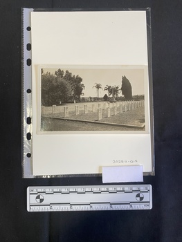 A black and white photo showing several rows of headstones.