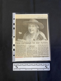 A newspaper clipping consisting of a title, three columns of text and a large black and white photo