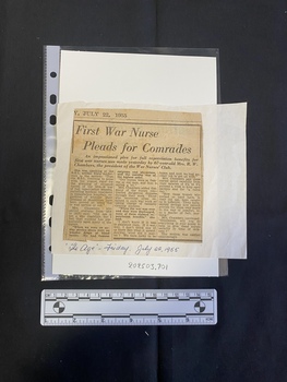 A newspaper clipping consisting of a title and three columns of text glued a large piece of white paper