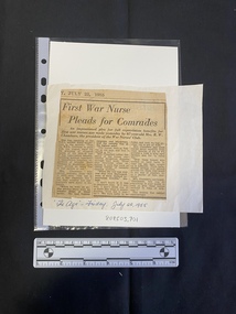A newspaper clipping consisting of a title and three columns of text glued a large piece of white paper