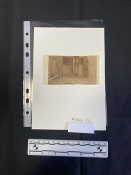 A black and white print of a photo cut from a larger piece of paper