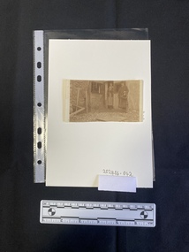 A black and white print of a photo cut from a larger piece of paper