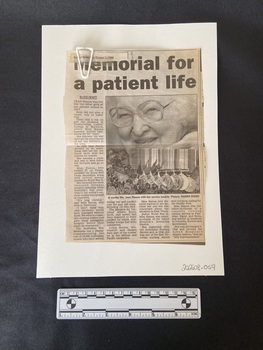 Newspaper clipping with title in bold across two lines at the top, followed by a large square photo of Jean Hanna holding up her medals below. To the left and below the photo are four columns of text.