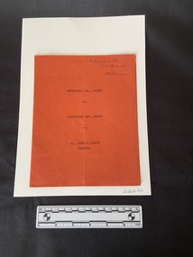 Staple-bound booklet with red card cover with title typed in black ink on the front.