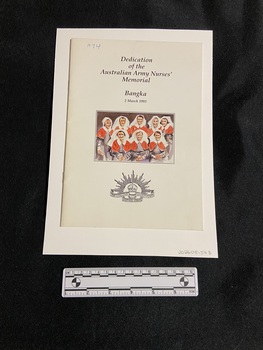 Staple-bound booklet with white cover. Title is printed in black ink in the top centre. The bottom centre displays the emblem of the Australian Commonwealth Military Force. In the middle is a coloured painting of eight nurses wearing the red capes and white veils.