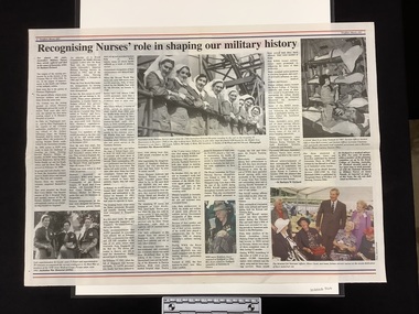 Centre newspaper spread with two colour photographs and three black and white photographs.  Article has ten columns of text.  Spread has a blue and red border at the top and bottom of the page, blue inside, red outside.