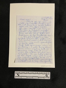 Handwritten letter in blue ink on lined paper. 