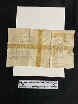 A very old, worn piece of paper in four pieces that have been taped together across the centre in both directions and on both sides.. The tape is now brittle and yellow and the print is quite faded in parts. There is an emblem of the 52nd General Hospital vaudeville group on the right hand side, the remaining areas are covered in black type.