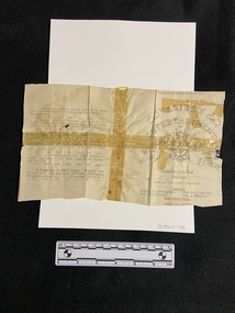 A very old, worn piece of paper in four pieces that have been taped together across the centre in both directions and on both sides.. The tape is now brittle and yellow and the print is quite faded in parts. There is an emblem of the 52nd General Hospital vaudeville group on the right hand side, the remaining areas are covered in black type.